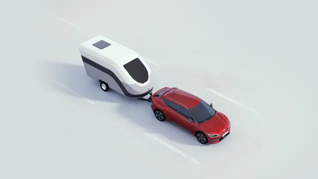 Kia EV6 in rot auf Strasse mit H&auml;nger